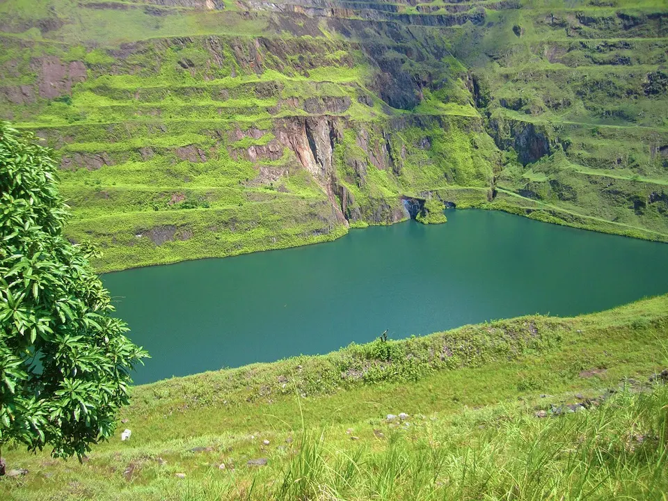Turquoise lake beneath green slopes — Montserrado, Liberia
