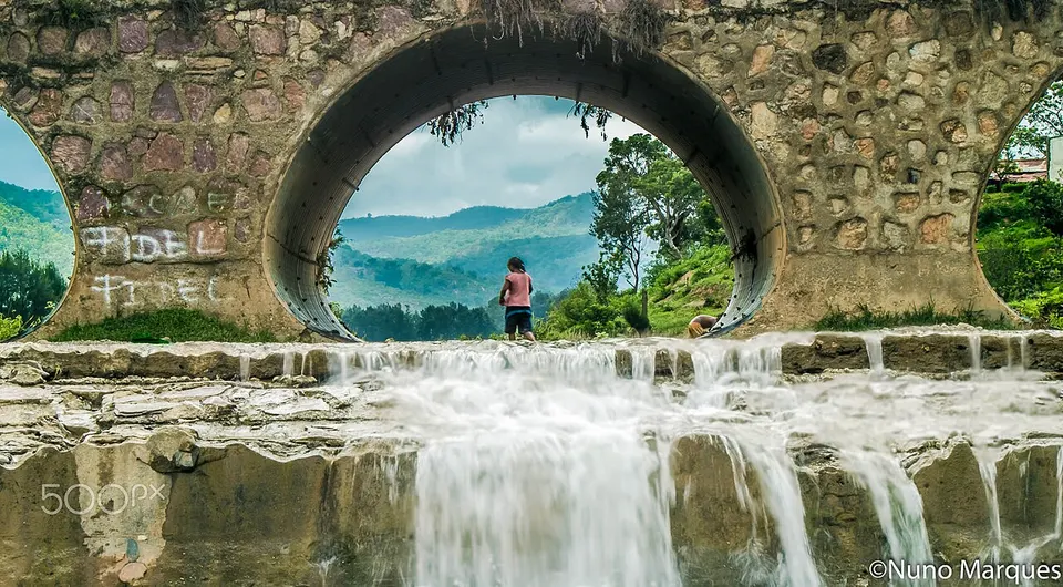 Water flowing through a stone arch — Aileu, Timor Leste