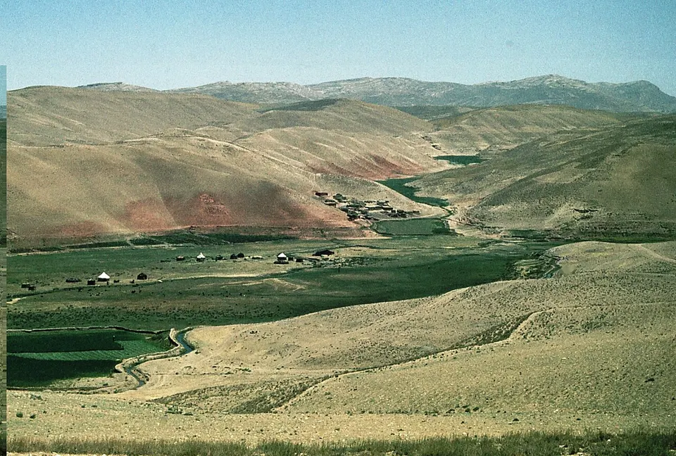 Irrigation ditch leads into fertile valley with nomad settlings - panoramio — Balkh, Afghanistan