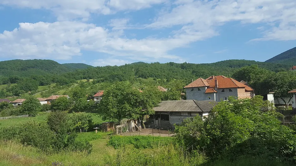 Village in a green wooded landscape — ALBA, Romania