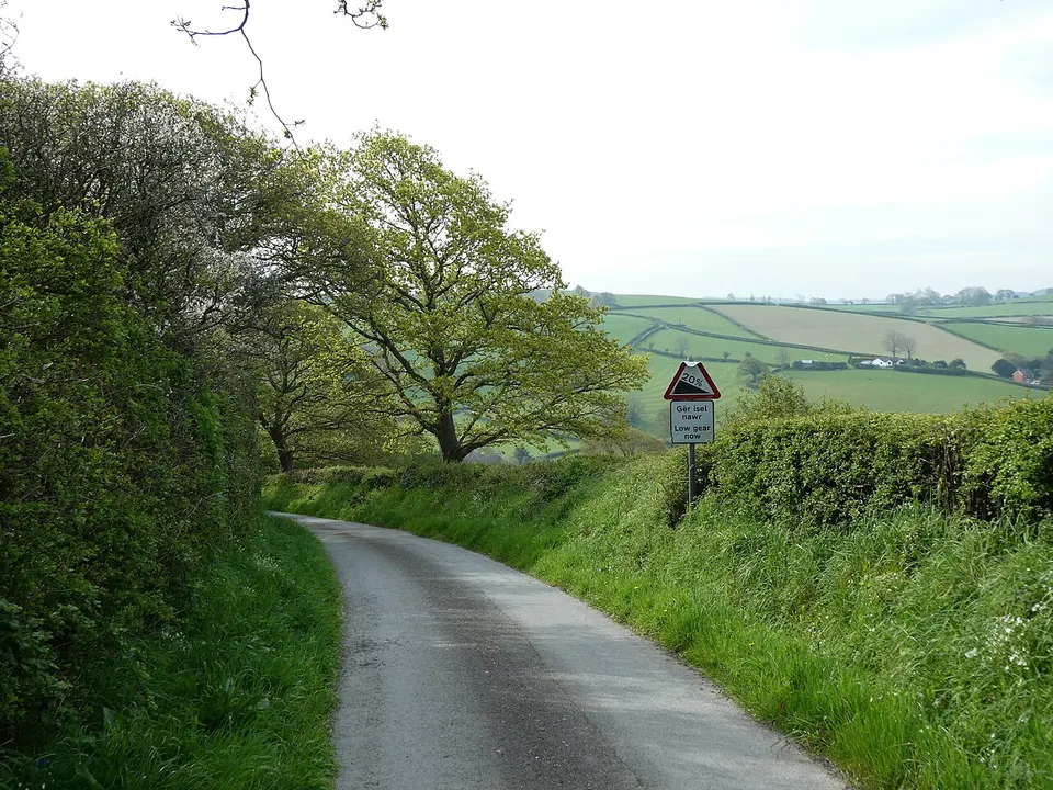 Country lane and rolling green hills — Wales, United Kingdom